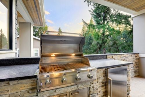 outdoor kitchen and grill in backyard 