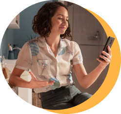 smiling woman looking at phone