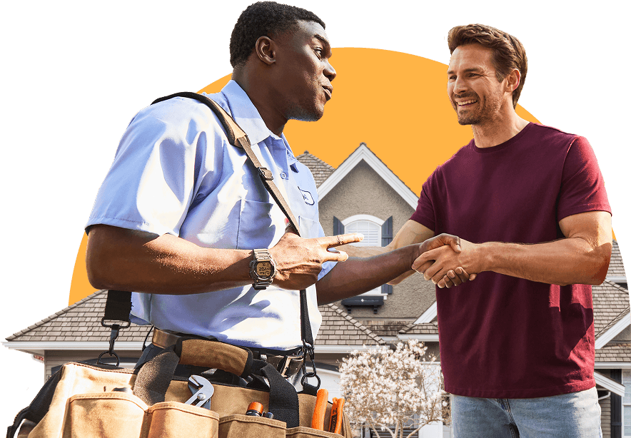 Two men shaking hands in front of a house. One of the men is a contractor.